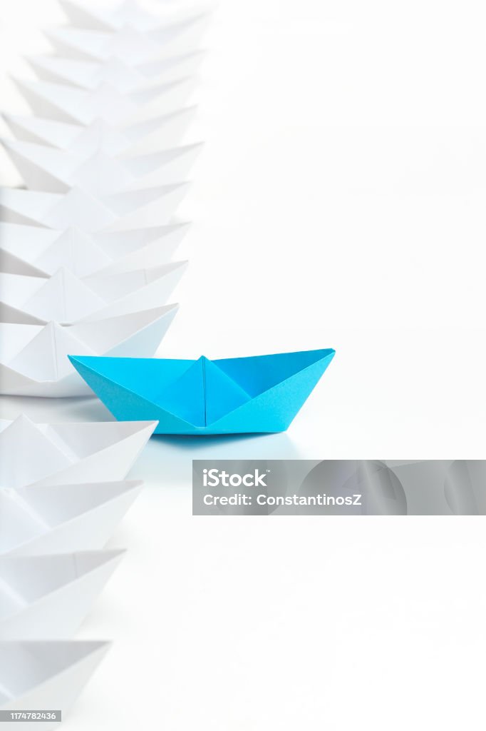 paper boat race blue paper boat leading the race against white ones Leadership Stock Photo