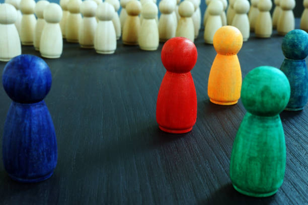 istock Inclusion and equality concept. Wooden figurines with different colors. 1174783707