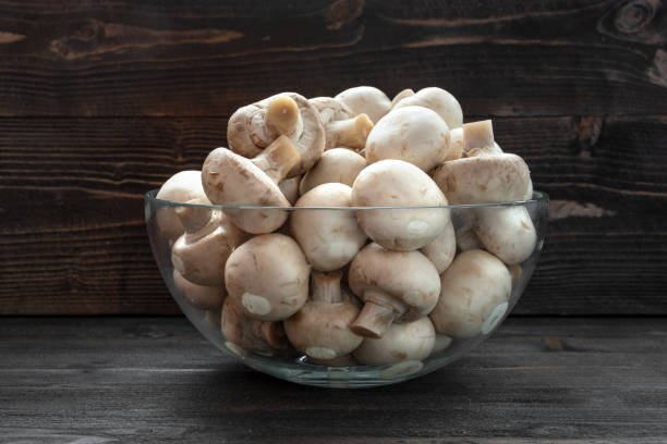 istock mushrooms mushroom on dark wooden table desk 1174785109