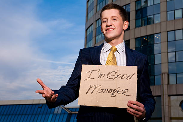 Businessman holding sign I am good Manager outdoors stock photo