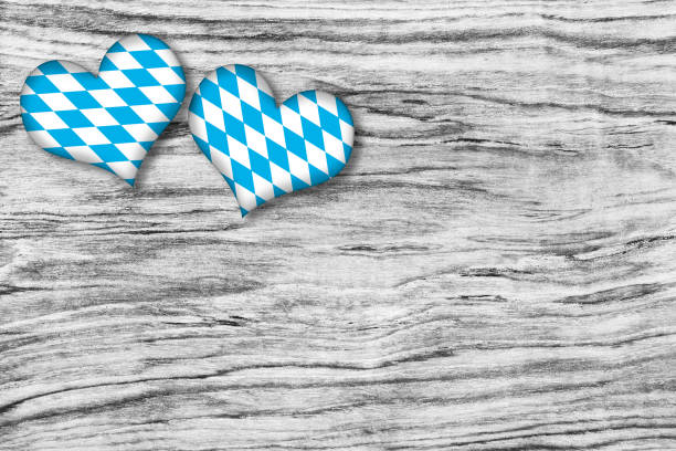 Beer Fest background with Dirndl and copy space gingerbread heart on wooden table.