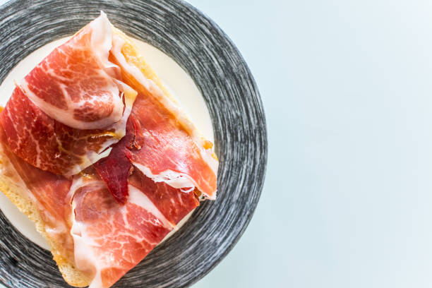 istock Toasts with ham serrano served on plate. 1174791573