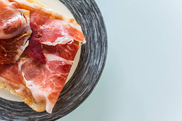 istock Toasts with ham serrano served on plate. 1174791582
