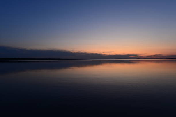istock Blue sky in twilight over a mirrored calm surface of the lake 1174791792
