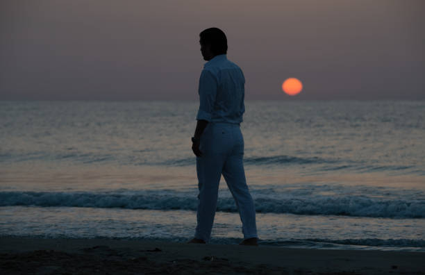 istock Man enjoying colorful sunset or sunrise 1174791865
