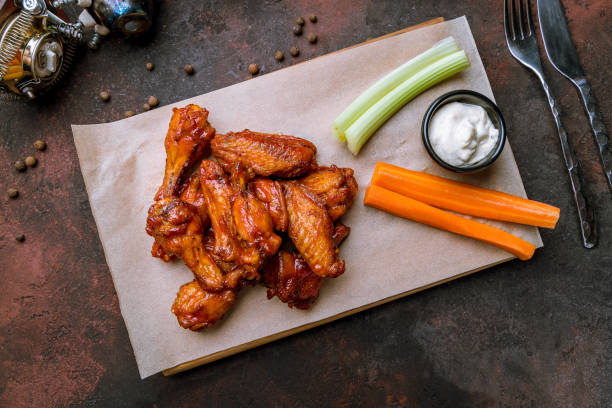 istock chicken wings in barbecue sauce and with blue cheese sause on dark rustic concrete table 1174795838
