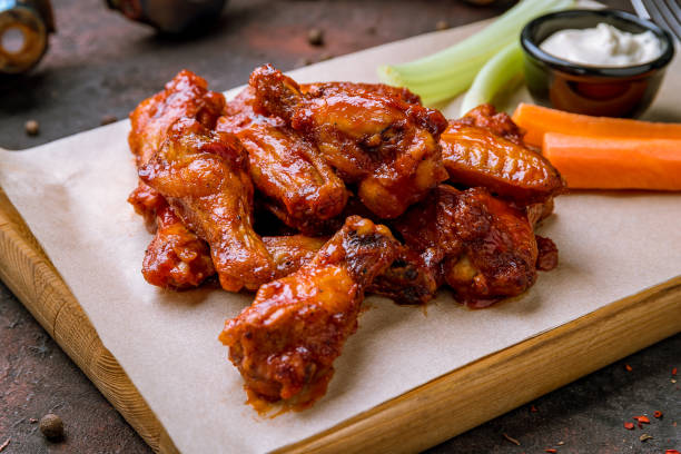 istock chicken wings in barbecue sauce and with blue cheese sause on dark rustic concrete table 1174795847