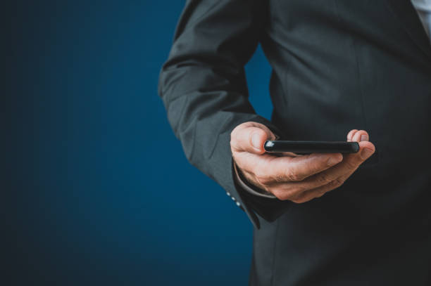 istock Businessman holding smart phone 1174797682