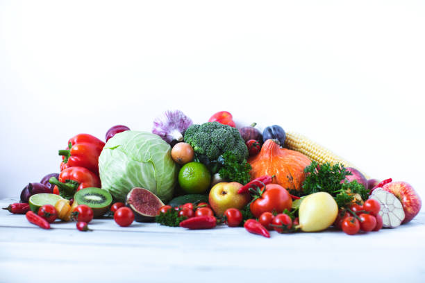 istock Various fresh vegetables and fruits on a wooden background, top view, copy space. 1174798697