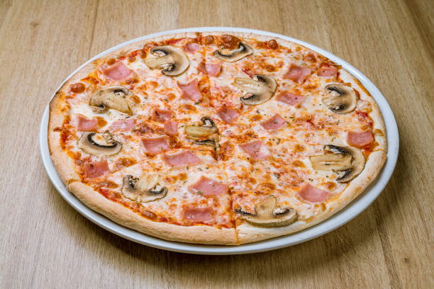 Pizza with ham and mushrooms stock photo