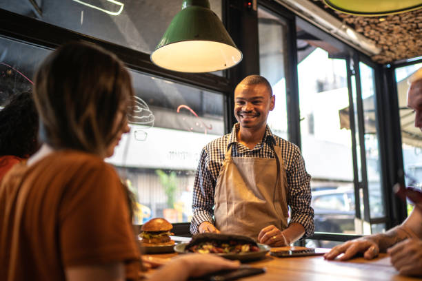 istock Waiter talking to some customers at restaurant 1174805020