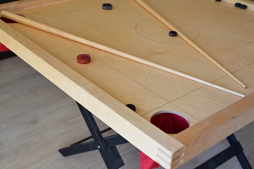 Novuss game board with pool cues