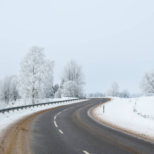 istock S-shape rural road through a winter wonderland with rime 1174805913
