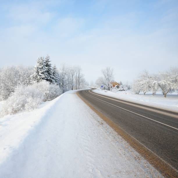 istock S-shape rural road through a winter wonderland with rime 1174805926