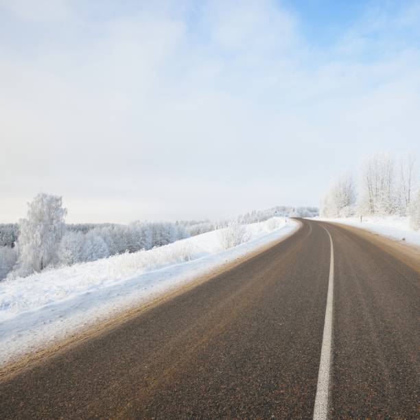 istock S-shape rural road through a winter wonderland with rime 1174805927