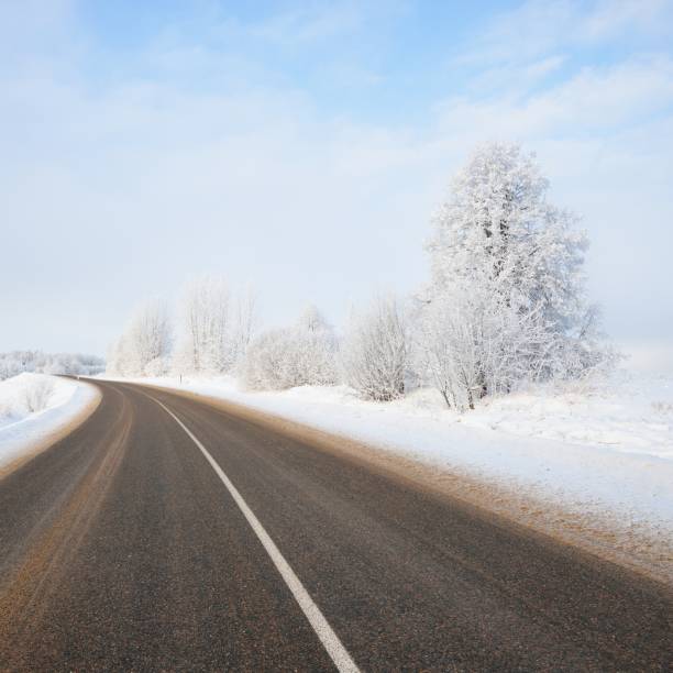 istock S-shape rural road through a winter wonderland with rime 1174805942