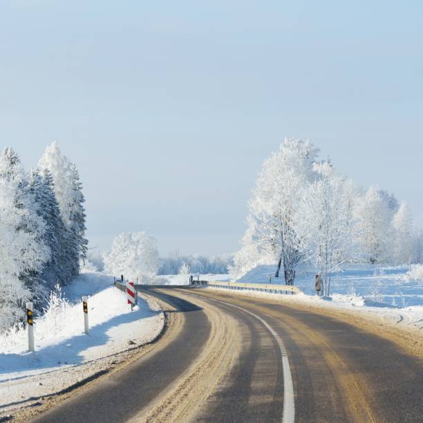 istock S-shape rural road through a winter wonderland with rime 1174805955