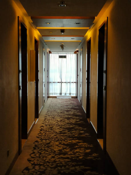 hotel corridor with brown doors and white walls