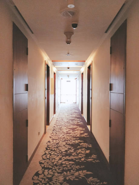 istock hotel corridor with brown doors and white walls 1174807562