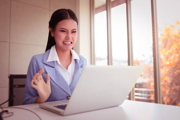 istock Young woman was so angry red face talking through laptop. 1174807585