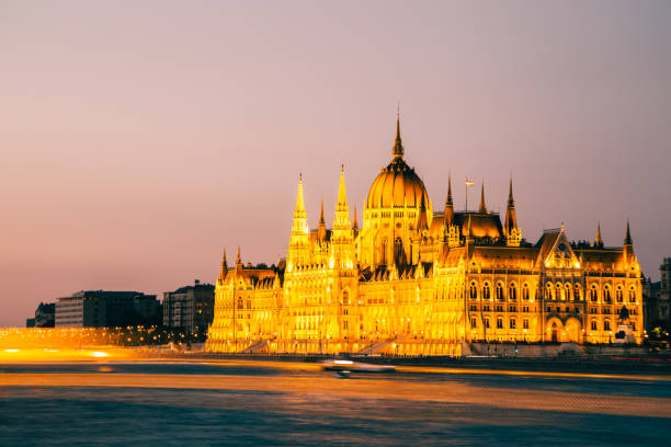bâtiment hongrois de parlement et vue de nuit de fleuve de danube à budapest, hongrie - budapest danube river cruise hungary photos et images de collection