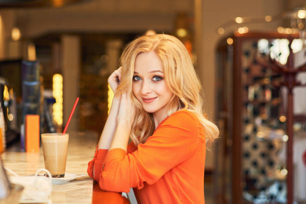 istock young lady is sitting at bar, smiling pleasantly 1174812989