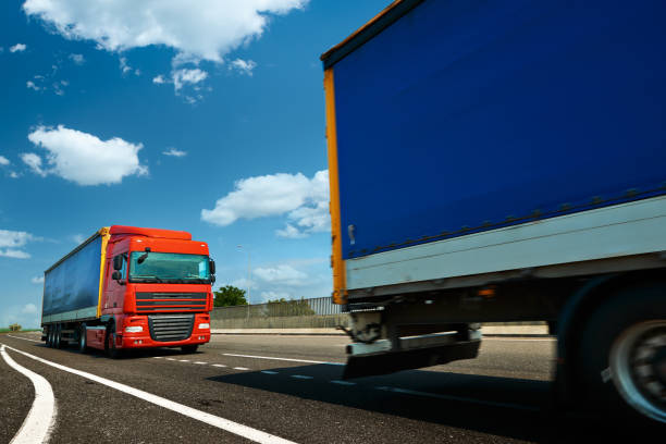istock Red truck is on highway - business, commercial, cargo transported 1174814967