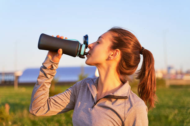 istock A young girl after workout drinking water 1174815200
