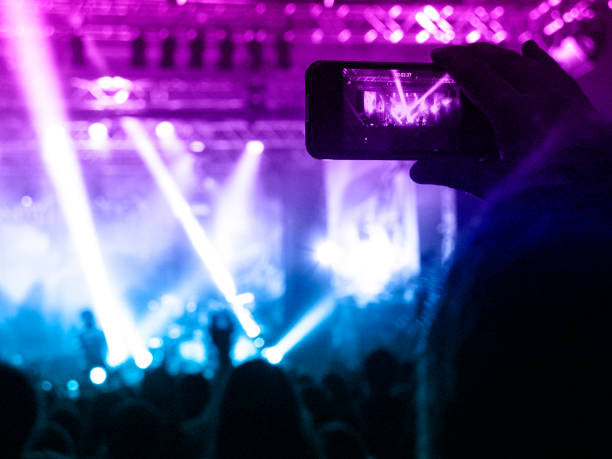 istock Filming concert on smart phone 1174815418