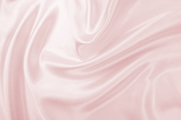 istock Delicate satin draped fabric pink texture for festive backgrounds 1174816012