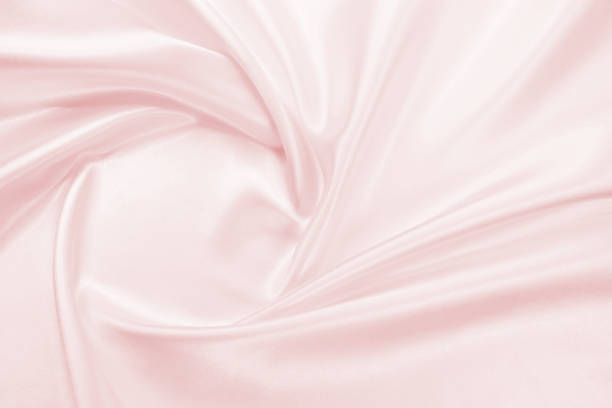 istock Delicate satin draped fabric pink texture for festive backgrounds 1174816013