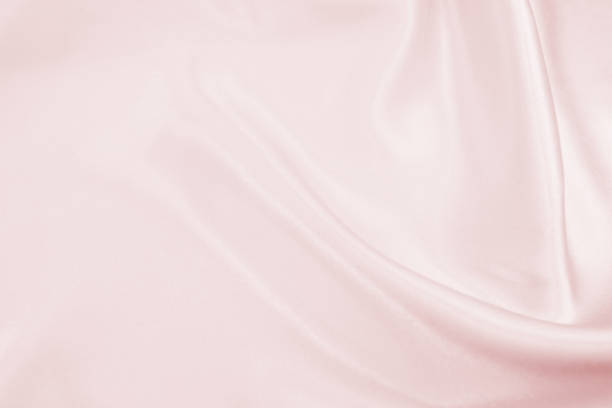 istock Delicate satin draped fabric pink texture for festive backgrounds 1174816041