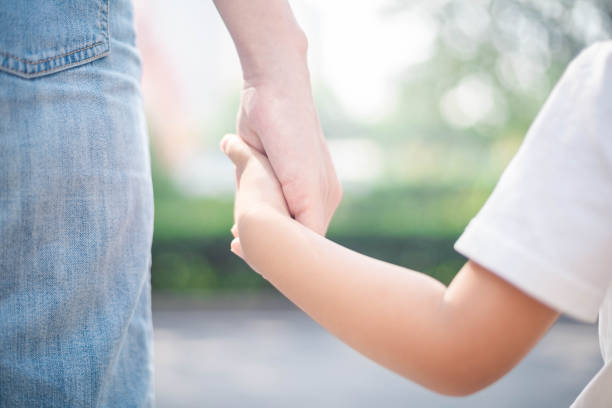istock Daughter holding mother's hand 1174816555
