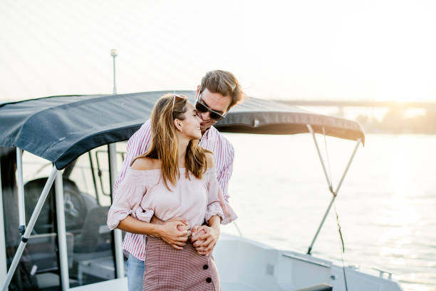 istock Young couple in love on the river dock 1174816701