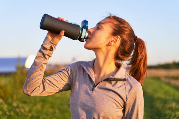 istock A young girl after workout drinking water 1174816743