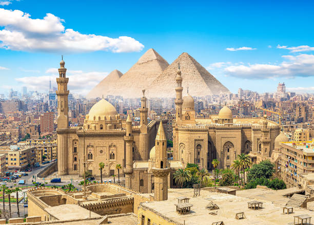 Mosque and pyramids View of the Mosque Sultan Hassan in Cairo and pyramids egypt skyline stock pictures, royalty-free photos & images