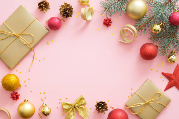 istock Flatlay Christmas holidays composition on pastel pink background with copy space. Top view Xmas tree fir branches, red and golden balls, gift box, pone cones. Christmas greeting card mockup. 1174818198