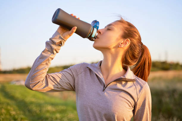 istock A young girl after workout drinking water 1174819124