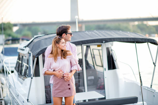 istock Young couple in love on the river dock 1174819925