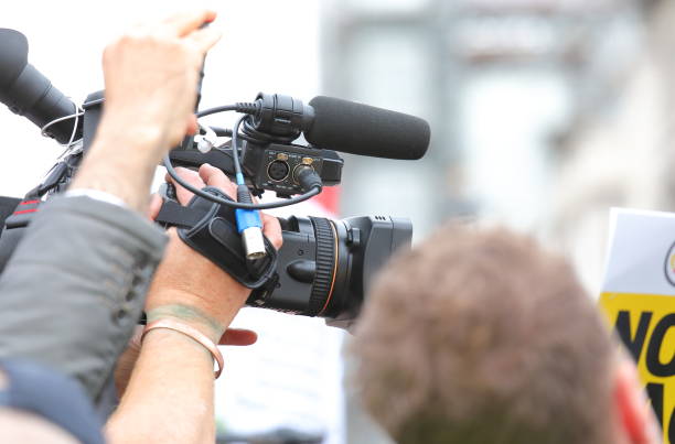 istock TV camera recording protest in crowd 1174820544