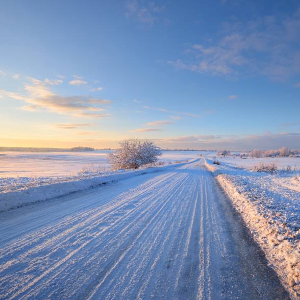 istock Snowcovered rural highway during winter sunset 1174822711