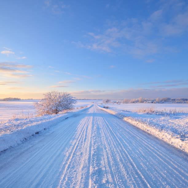 istock Snowcovered rural highway during winter sunset 1174822729