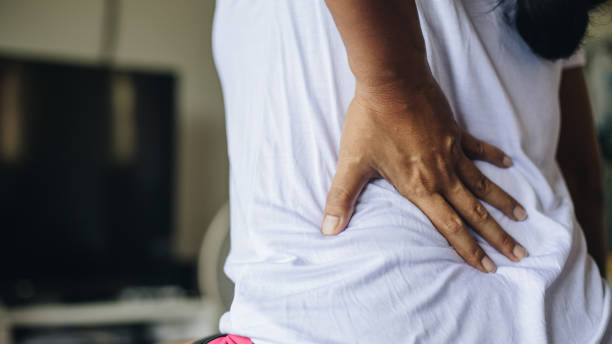 istock Close up view at woman touching aching back feeling lower lumbar muscular 1174822867