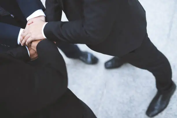 Photo of Close up of Group people of businessmen joining putting their hands together with stack of hands showing unity and teamwork. concept Success and encouragement to overcome obstacles. soft focus.