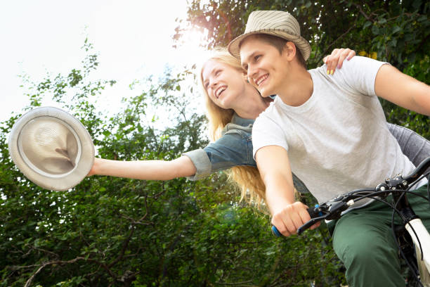 istock Young couple riding bicycle outdoors 1174824494