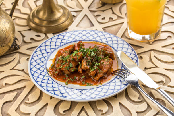 istock Meat stew with greens on oriental table background 1174825831