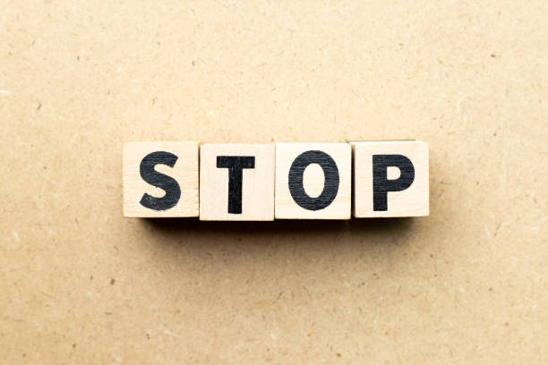 istock Letter block in word stop on wood background 1174827298