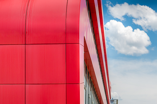 Modern red office building exterior. Square pattern background.