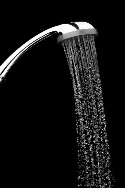 istock Water drops flowing from shower head in bathroom on black background ,stop motion 1174829599