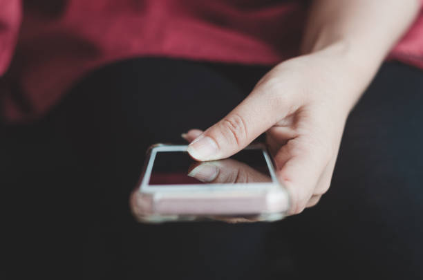 istock hipster woman using hands touching and typing on mobile phone screen search internet online working or social communication with digital 5G technology app device in coffee shop indoor lifestyle. 1174829652
